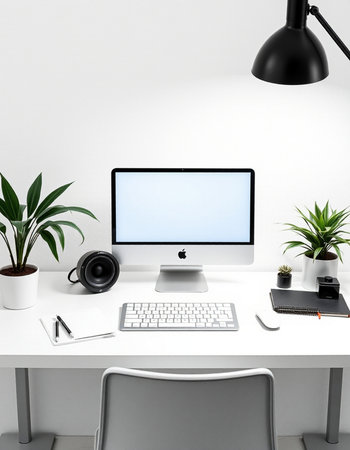 Modern workspace with computer, keyboard, mouse and plant.の写真素材