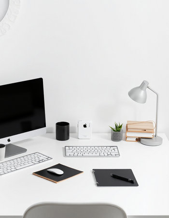 Minimalistic workplace with computer, keyboard, mouse, coffee cup and other items on white table. Workplace conceptの写真素材