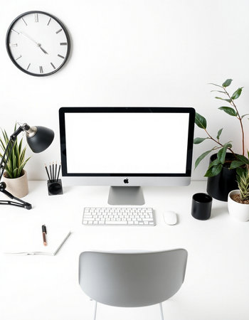 Modern workspace with blank computer screen, stationery and coffee cup on white background.