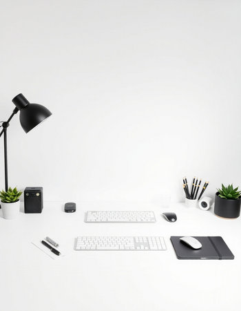 Minimal workspace with computer, keyboard, mouse, notebook, lamp and coffee cup on white backgroundの写真素材