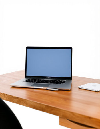 Laptop with blank screen on a wooden table isolated on white background