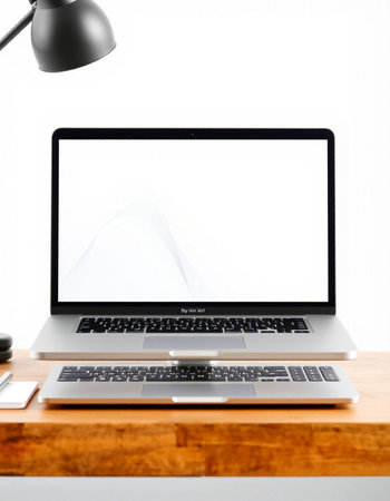 Laptop with blank screen on wood table and lamp on white wall background