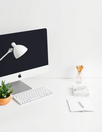 workplace with computer, stationery, lamp and plant on white backgroundの写真素材