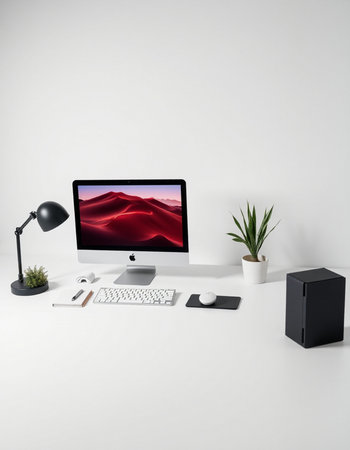 workplace with computer, lamp and plant isolated on white