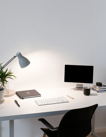 Modern workplace with computer, stationery and lamp on white wall background