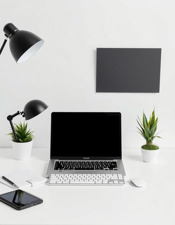 Laptop with blank screen on white office desk. Workplace background