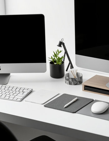Workplace with modern computer, stationery and plant on table in office