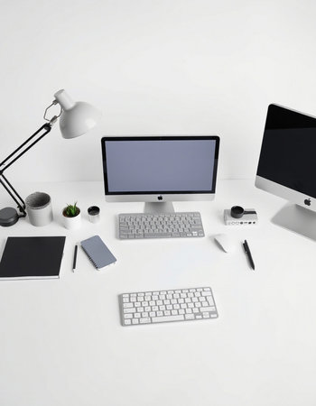Office workplace with computer, tablet, coffee cup and other supplies