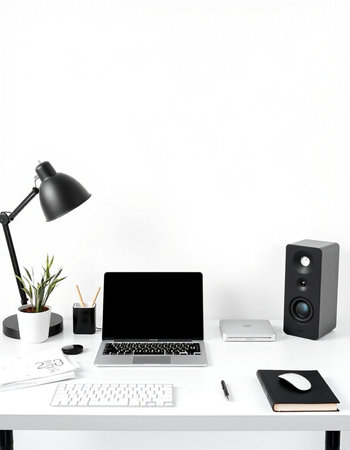 Workplace with laptop, notebook and stationery on white desk.