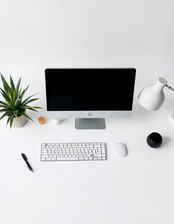 Top view of modern workspace with computer, keyboard, mouse, coffee cup, plant and other items. Mock...