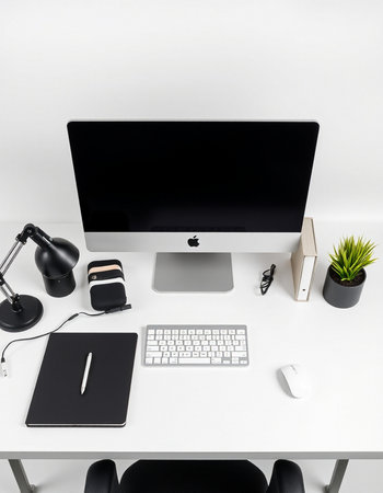 Top view of modern designer desktop with blank computer screen, stationery and decorations. Mock upの写真素材