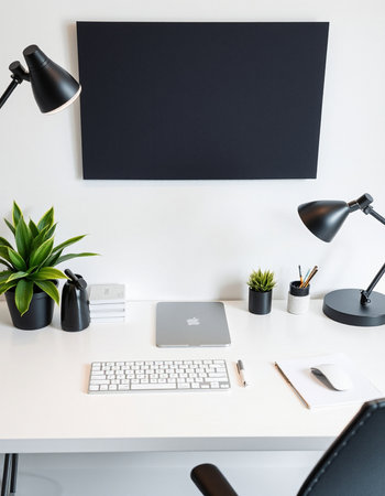 Creative designer workspace with blank black poster, laptop, coffee cup and other items. Mock upの写真素材