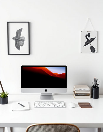 Modern workspace with computer, supplies and decorations on white wall.の写真素材