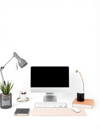 Modern workspace with blank computer screen, stationery, lamp and plant on white background