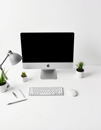 White office desk with computer, keyboard, mouse, pen and plant