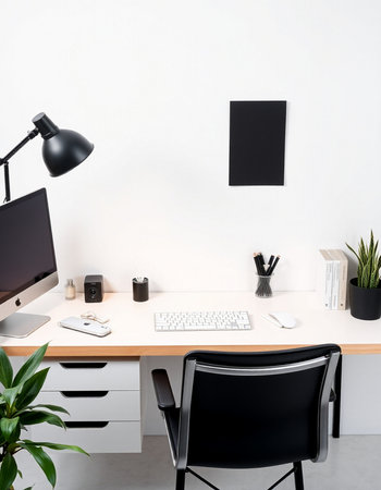 Modern workplace with computer, lamp and other items.