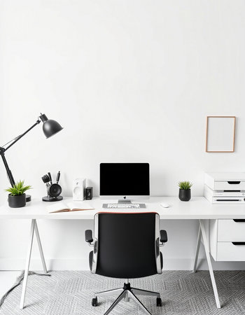 Workplace with laptop, stationery and plant in modern office interior