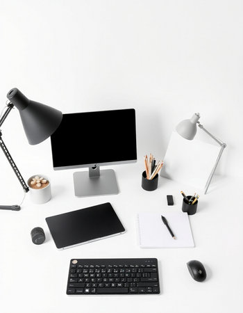 Workplace with computer, supplies and coffee cup on white background.