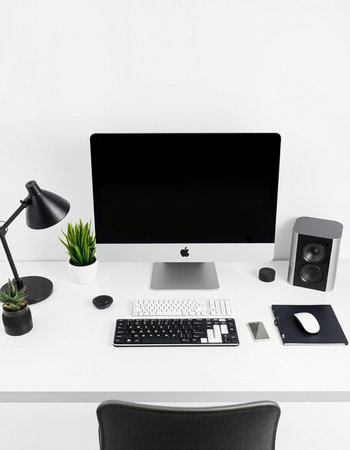 Front view of modern white office desktop with blank black computer screen, keyboard, mouse, coffee...