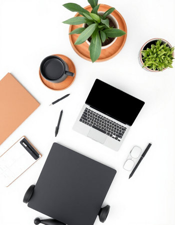 White office desk table with laptop, notebook, coffee cup and plant. Top view with copy space. Flat...