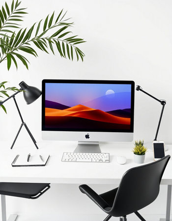 workplace with computer, keyboard, mouse, lamp and plant on white table