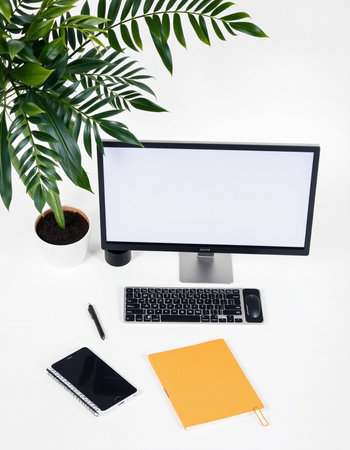 Modern workspace with computer, keyboard, notebook and plant on white backgroundの写真素材