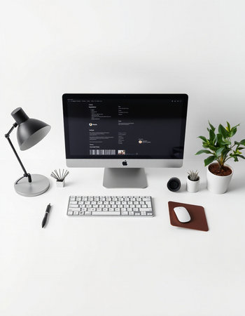 modern designer desktop with computer, keyboard, mouse, coffee cup and other items