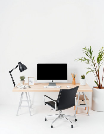 workplace with modern computer, lamp and plant on white wall background