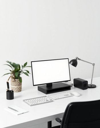 Mockup computer with blank screen on office desk in front of white wallの写真素材