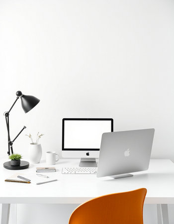 Workplace with modern computer, lamp and coffee cup on white tableの写真素材