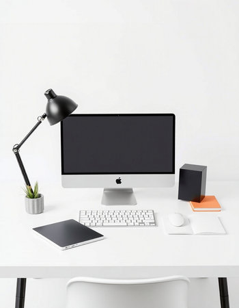 Modern workplace with keyboard, mouse and lamp on white tableの写真素材