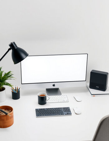 Modern desktop with blank computer screen, keyboard, mouse, coffee cup and other items. Mock upの写真素材