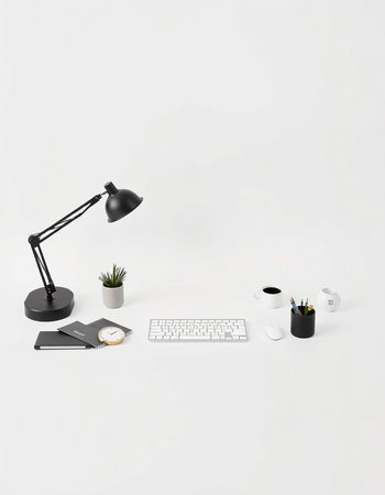 Office desk with keyboard, mouse, coffee cup, notebook, lamp, pencils and other objects.