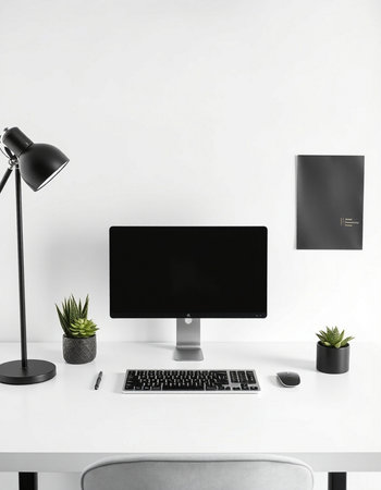Modern workplace with computer, lamp and stationery on table in office