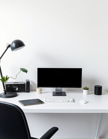 workplace with blank screen computer, lamp and coffee cup on white tableの写真素材
