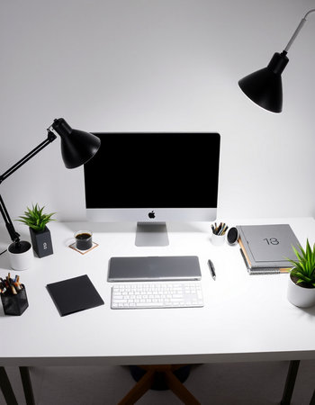 Modern workplace with computer, supplies and coffee cup on white table.の写真素材