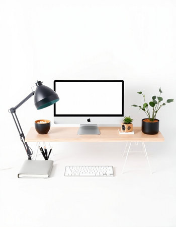 Modern workplace with computer, lamp and cup of coffee on white background