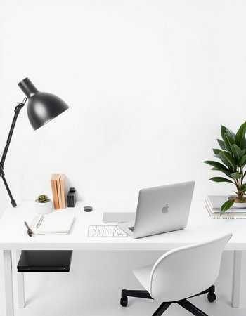 Modern workplace with laptop, stationery and potted plant on tableの写真素材
