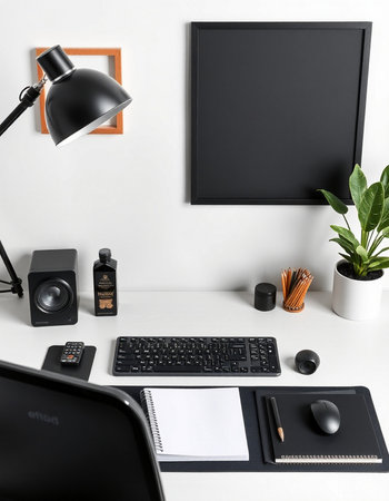 Workplace with computer, lamp and stationery on white wall backgroundの写真素材