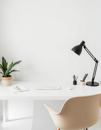 Minimalist workplace with computer, stationery and plant on white table