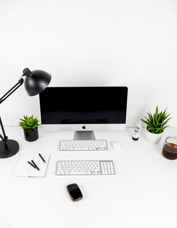 Modern workplace with computer, keyboard, mouse, coffee cup and accessories on white backgroundの写真素材