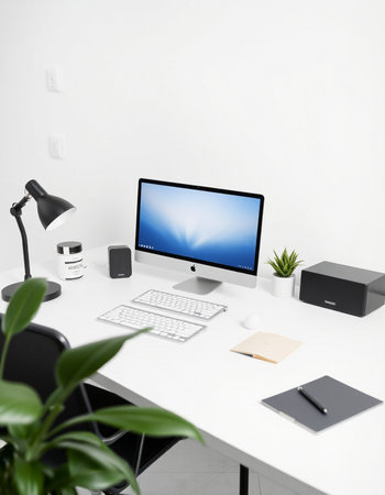 workplace with computer and stationery on white table in modern officeの写真素材