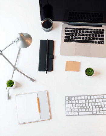 White office desk table with laptop, smartphone, coffee cup, notebook and decorations. Top view with copy space, flat layの写真素材