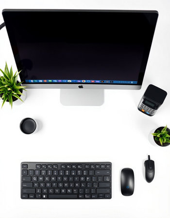 Workplace with computer, mouse, keyboard and plant on white backgroundの写真素材