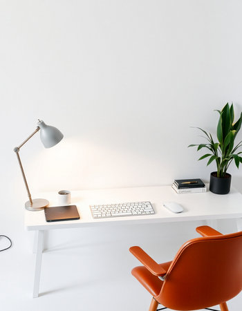 Interior of a modern office with orange chair, keyboard, lamp and plantの写真素材