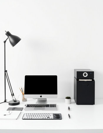 Workplace with computer, lamp and stationery on table in office