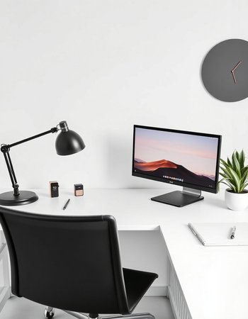 Workplace with computer, lamp and stationery on table near wallの写真素材