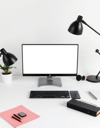 Modern workplace with blank screen computer, stationery and coffee cup on white backgroundの写真素材