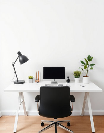 workplace with computer, lamp and plant on the white wall background