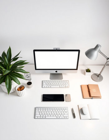 Modern workplace with computer, supplies and coffee cup on white background.の写真素材